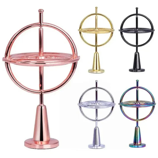 Orbitrix gyroscope shown in all five finishes: gold, silver, pink, black, and rainbow