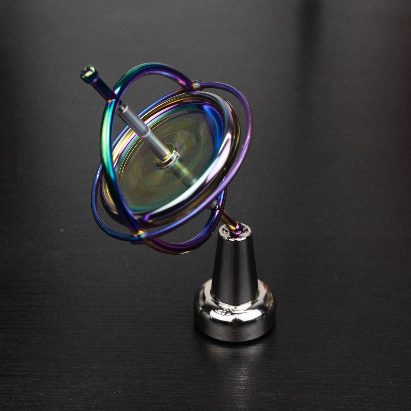 Orbitrix rainbow gyroscope tilted on its stand
