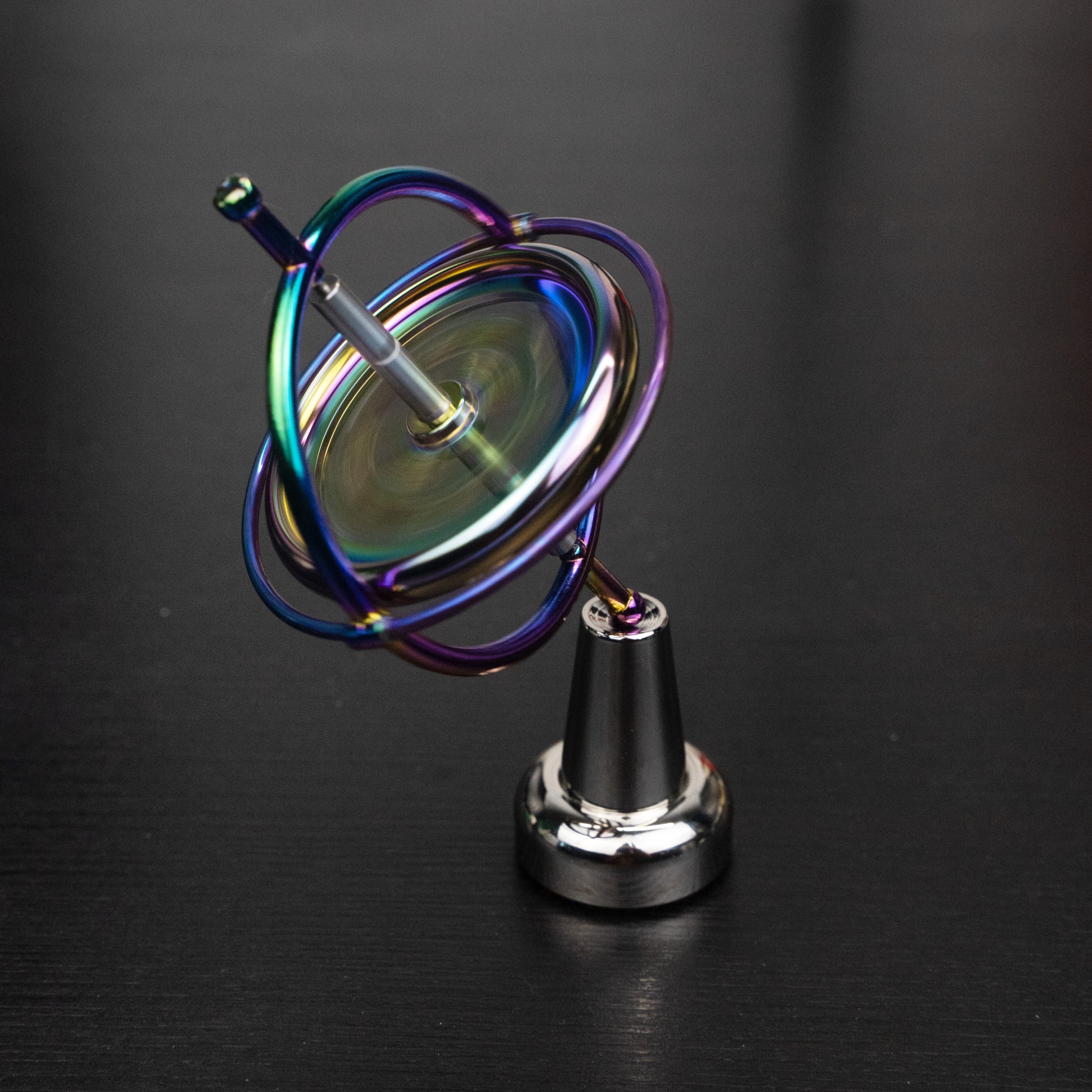 Orbitrix rainbow gyroscope tilted on its stand