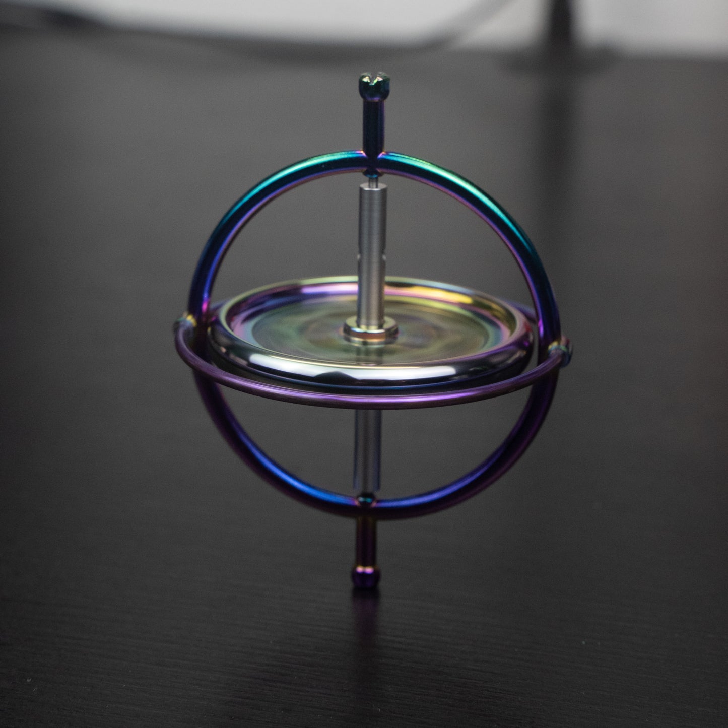 Orbitrix rainbow gyroscope viewed from above, showing the spinning rings