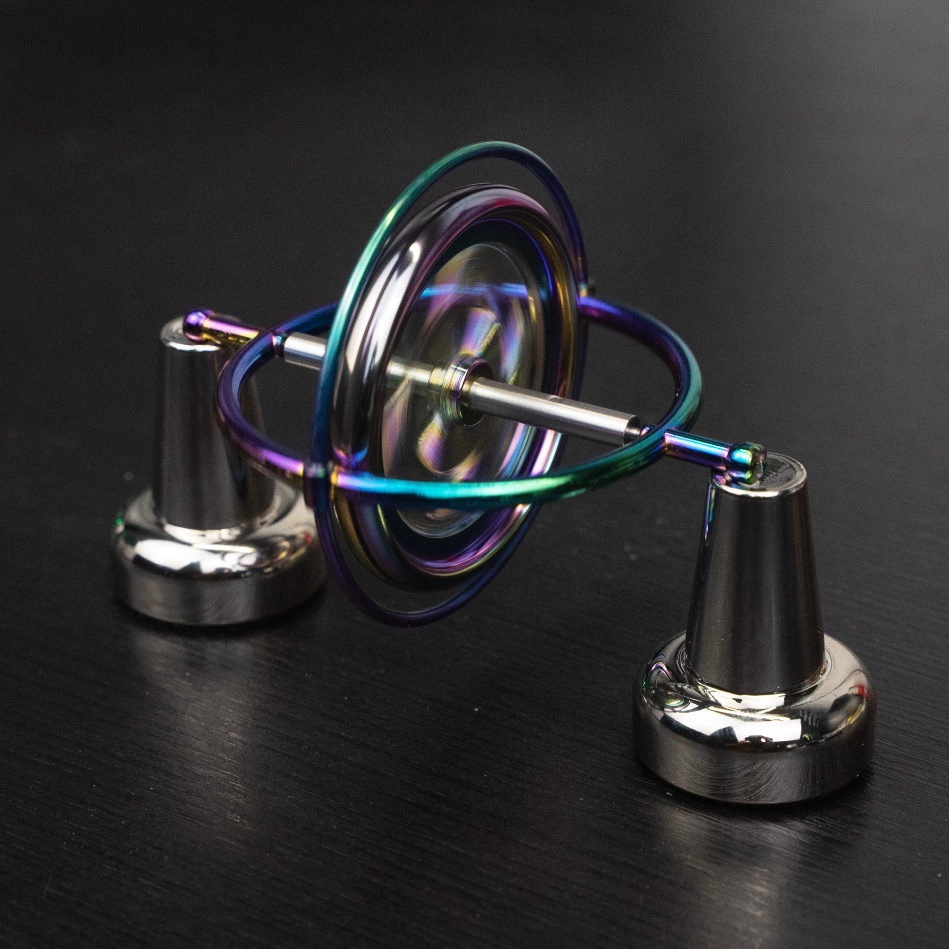Orbitrix rainbow gyroscope balanced on a two-point stand